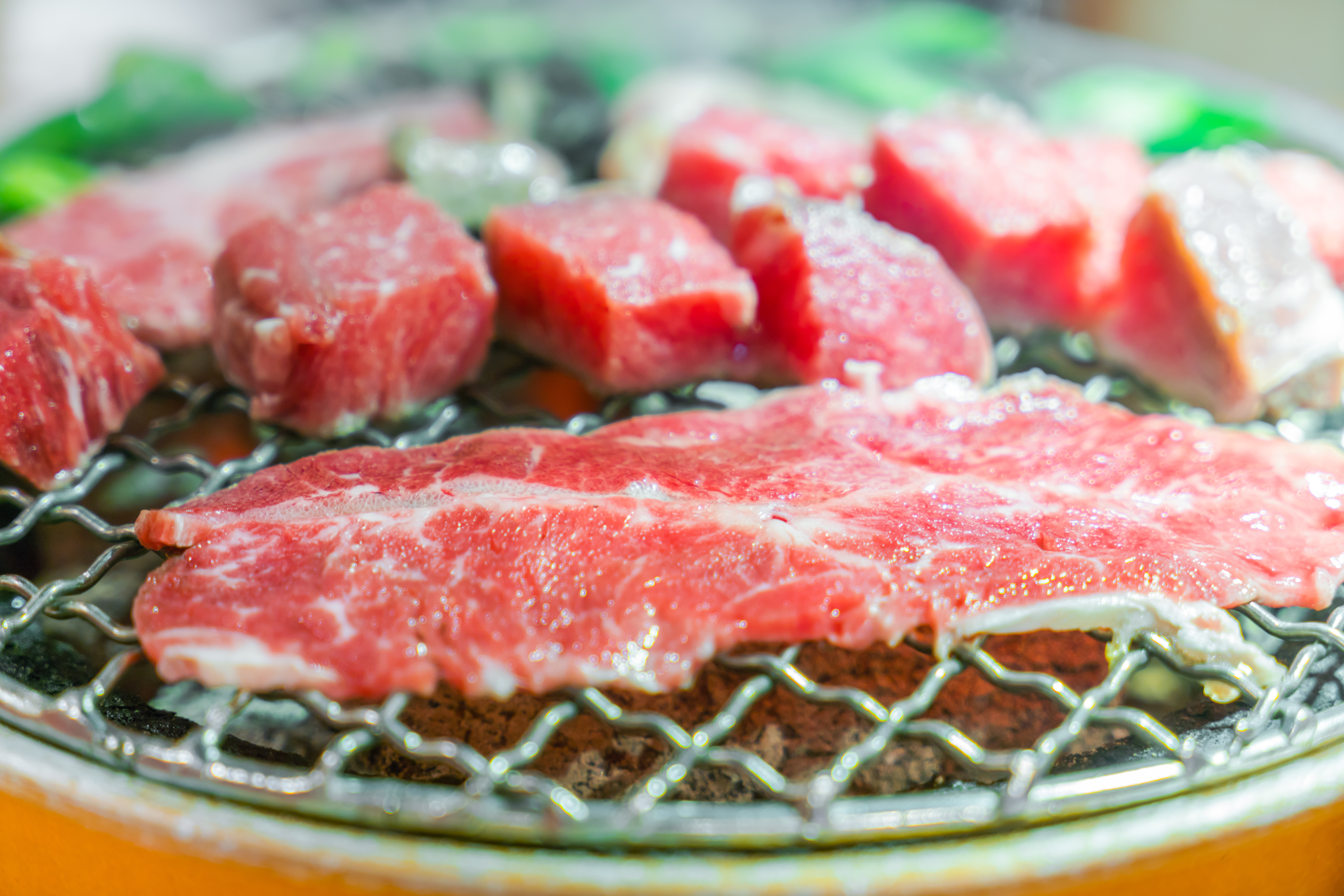 japanese style raw fresh beef on hot barbecue grill .